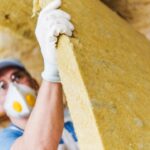 Man with eco-friendly option of mineral wool for roof insulation